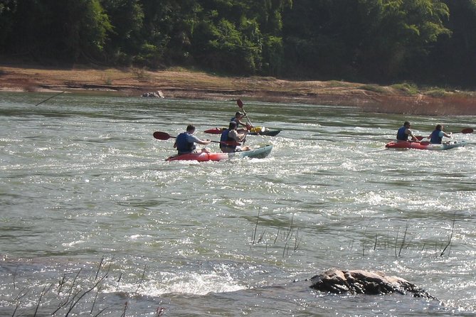 FULL DAY – Kuang Si Waterfall, Kayak on the Nam Ou / Mekong River, Pak Ou Caves - Whisky Village adds a quick roadside pause